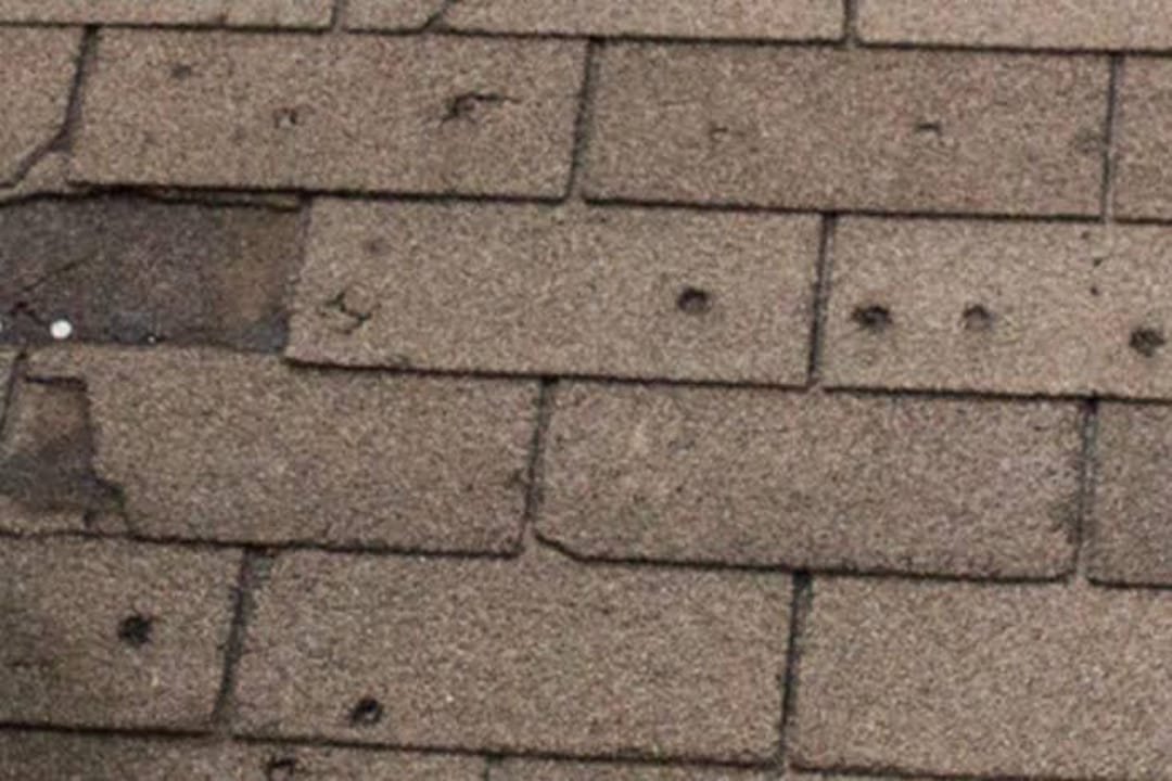 Storm-damaged shingles with missing tabs Knoxville