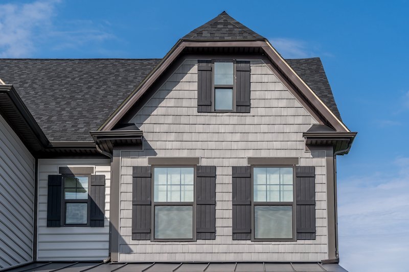 Double-hung replacement windows on a gable with shutters Knoxville
